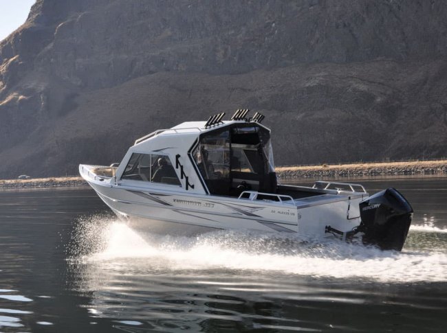 a thunderjet alexis crossover fishing and utility boat motoring across clear waters.