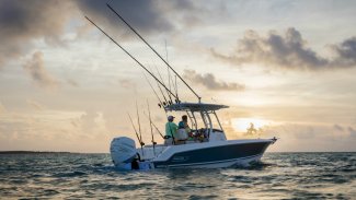 a Boston Whaler 230 outrage boat drifting in front of a picturesque Gordon Bay sunset.