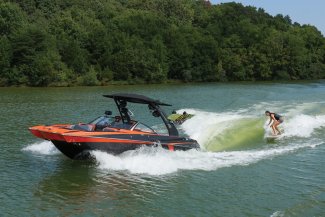 malibu wakesetter boat careening down a beautiful cottage lake