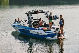 a malibu 23 mxz with a crew of friends having fun aboard.
