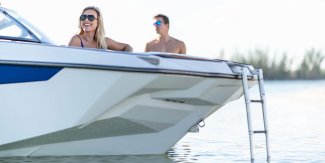 A man and women sitting in a boat looking at the water in Muskoka near Toronto Ontario