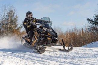 A man driving a snowmobile