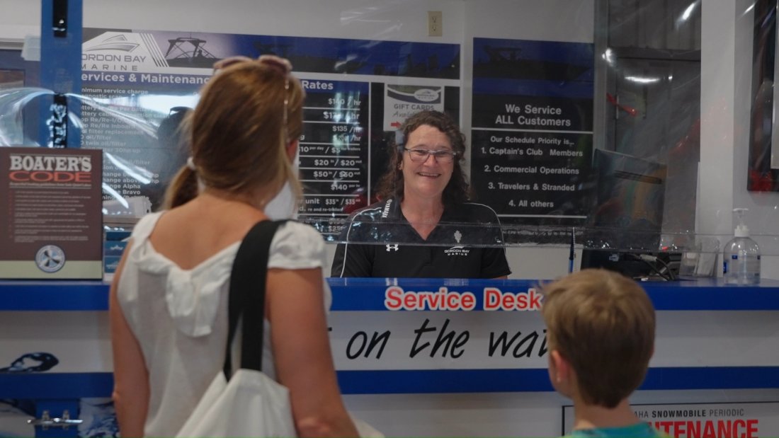 woman at service counter talking to customers