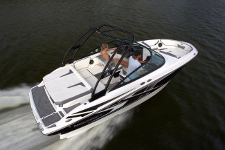 A Monterey M20 skipping along the water with a young couple.